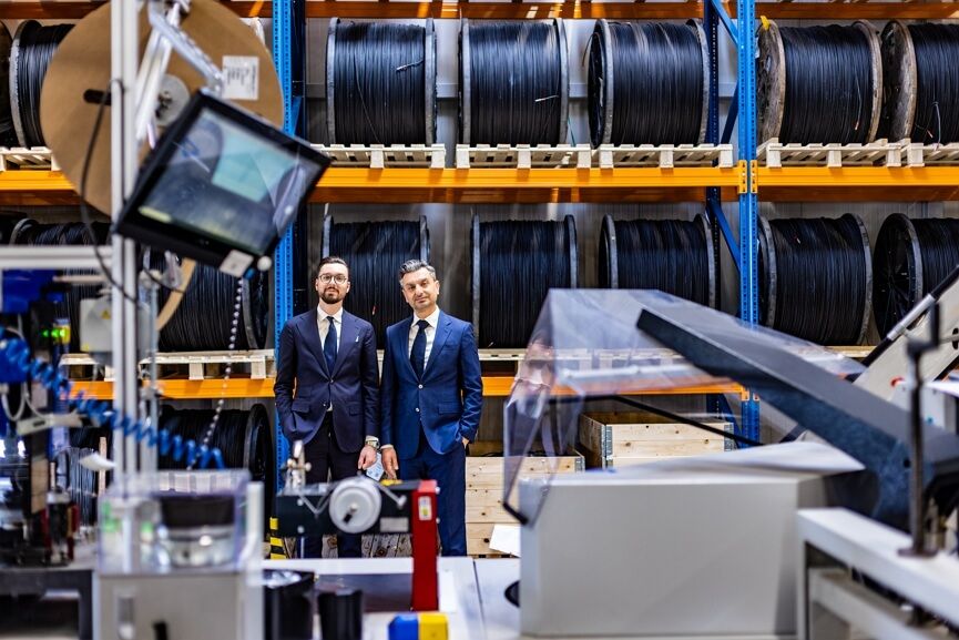 Company owners in front of cable drums